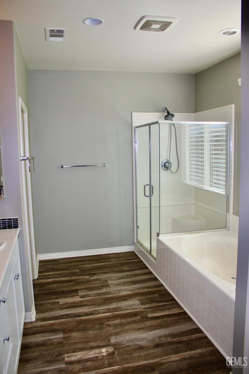 Undisclosed Address Bakersfield, CA 93313 - Photo 11 of 26 a bathroom with a bathtub and a shower