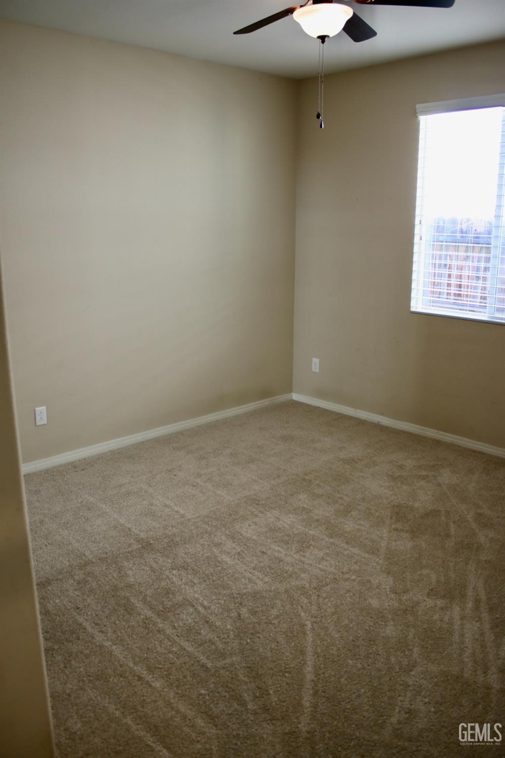 Undisclosed Address Bakersfield, CA 93313 - Photo 12 of 26 en empty room with a window