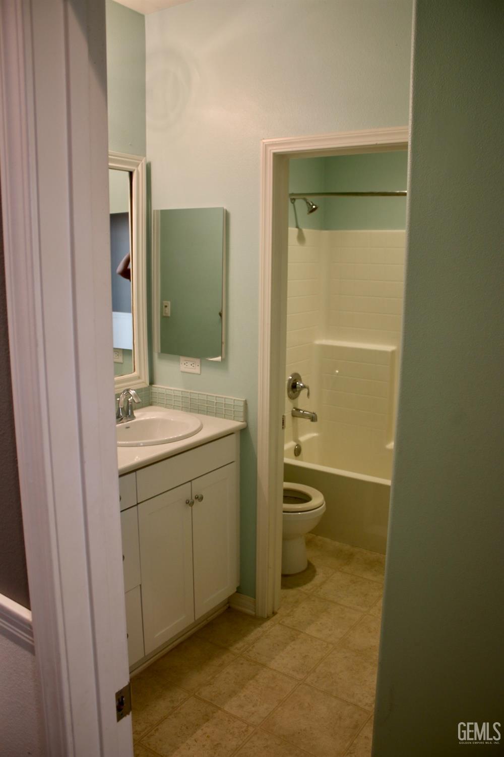 Undisclosed Address Bakersfield, CA 93313 - Photo 13 of 26 a bathroom with a granite countertop sink toilet and shower