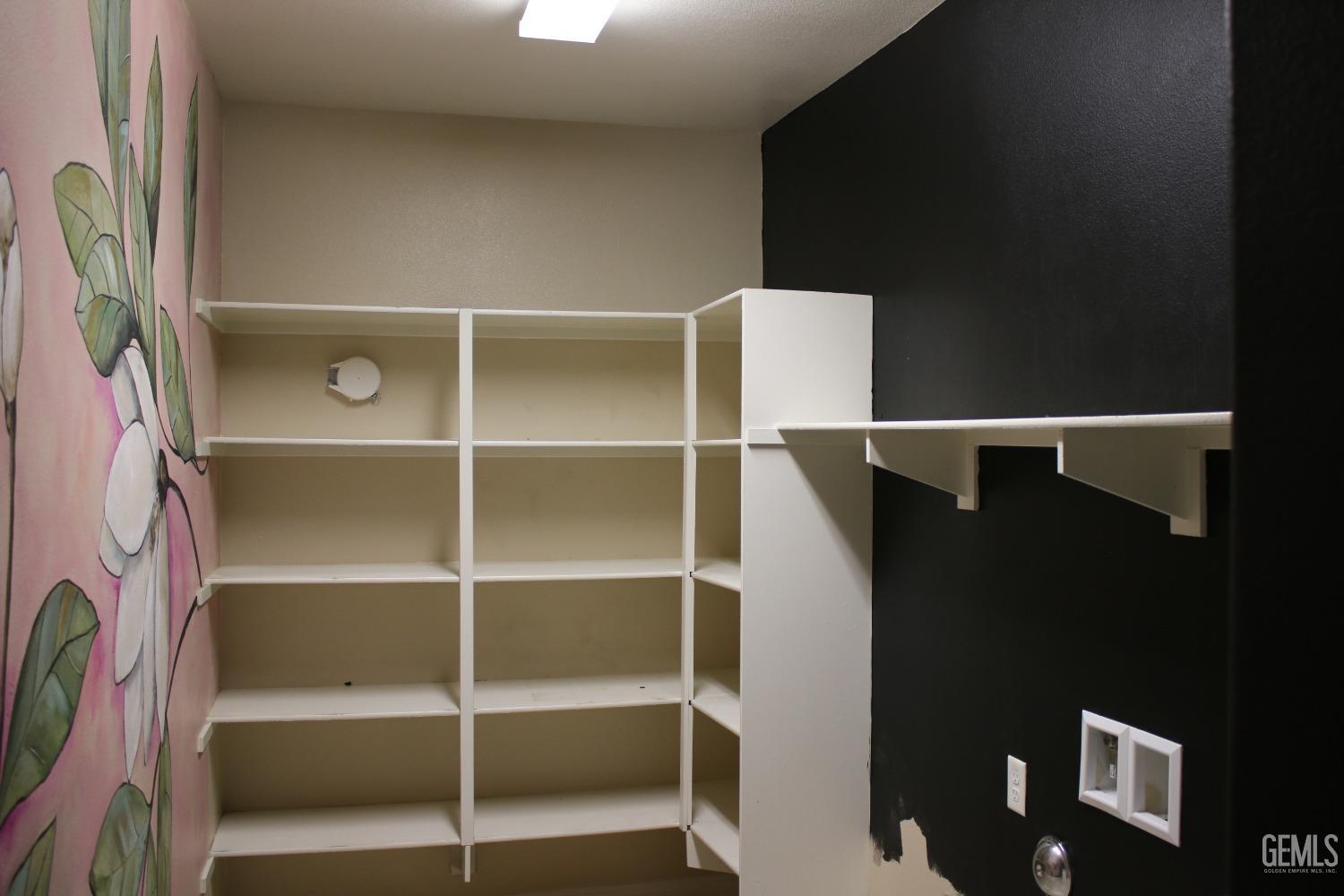 Undisclosed Address Bakersfield, CA 93313 - Photo 18 of 26 a view of walk in closet with empty racks