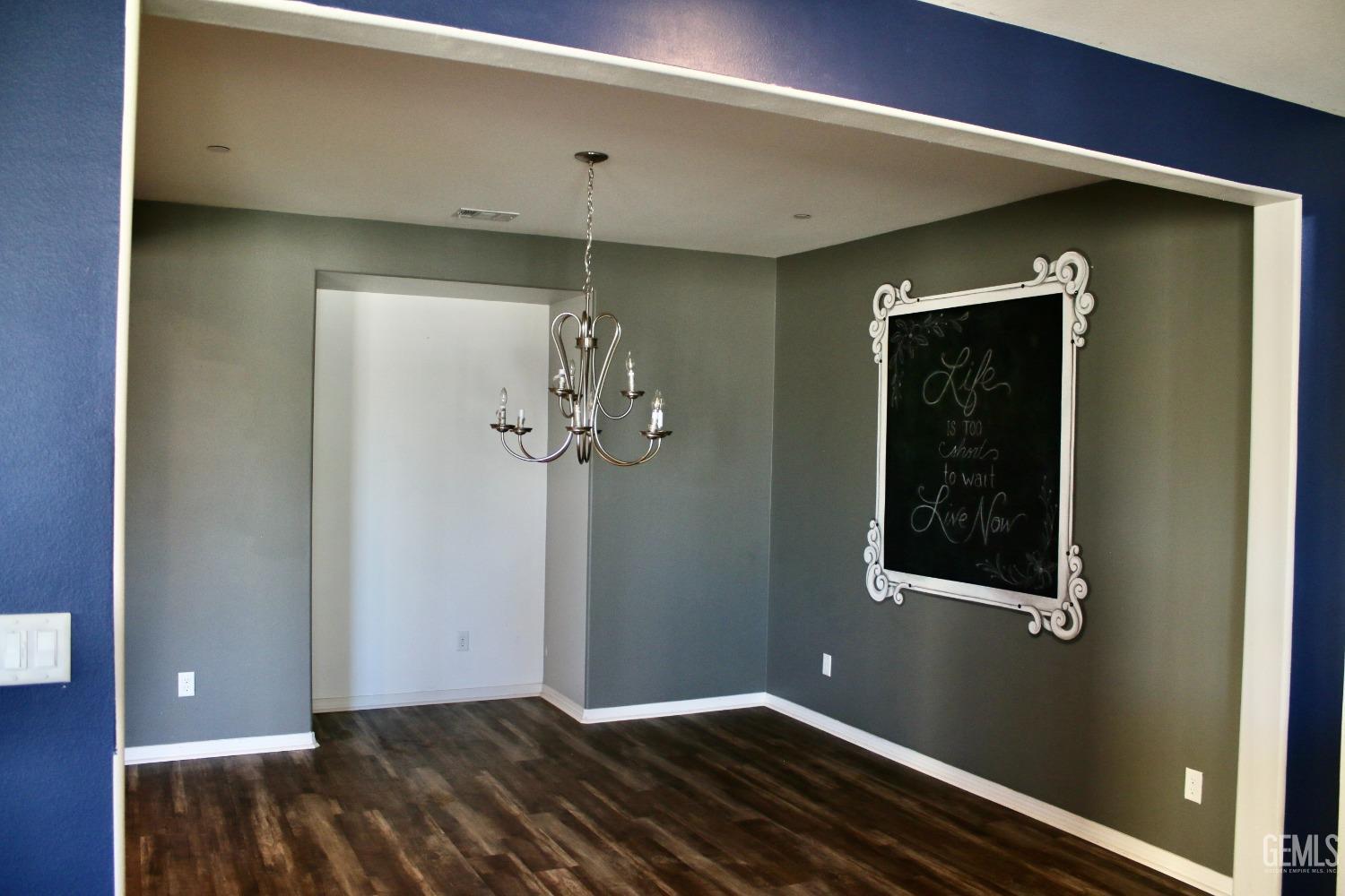 Undisclosed Address Bakersfield, CA 93313 - Photo 7 of 26 a view of a hallway with wooden floor and a bathroom