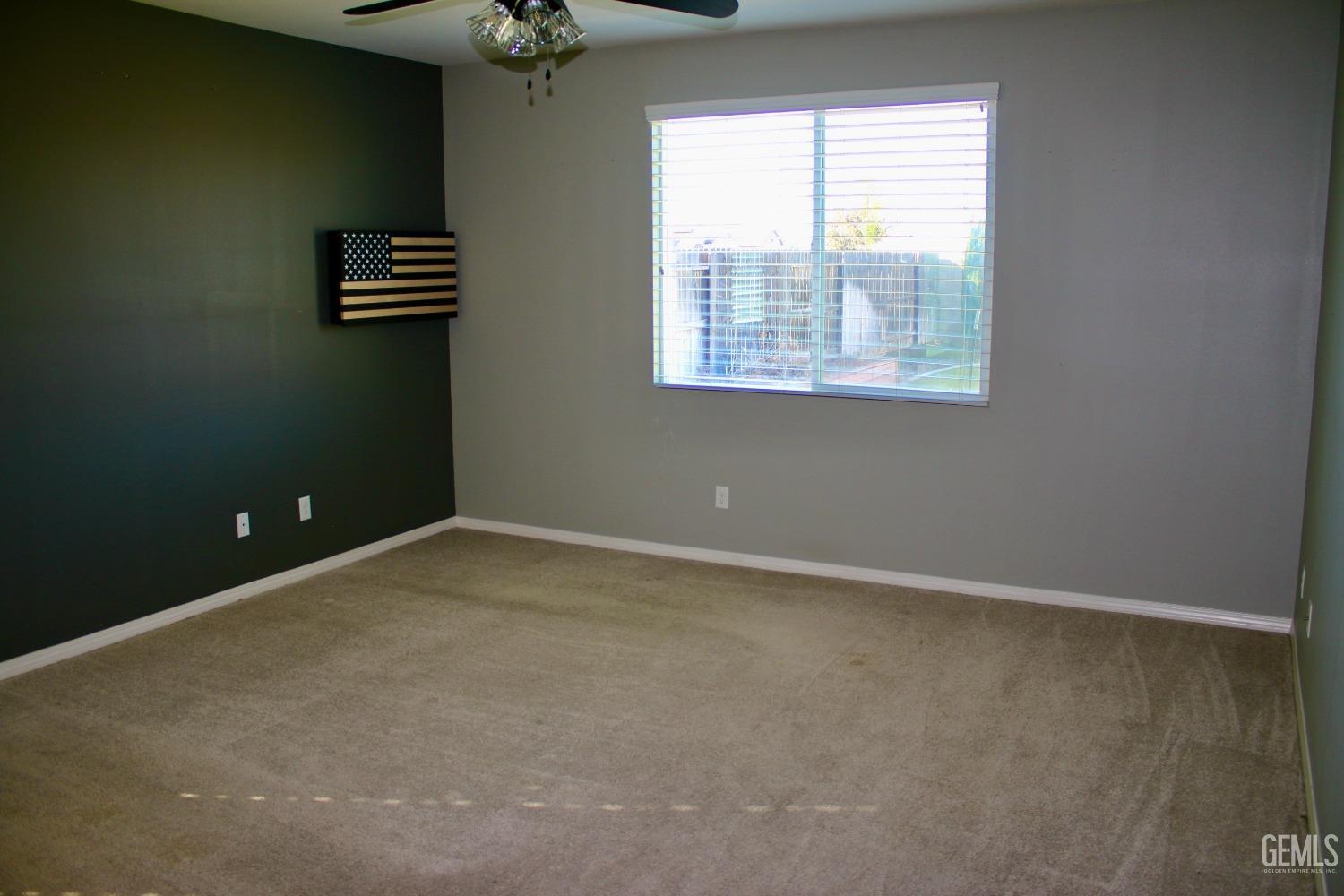 Undisclosed Address Bakersfield, CA 93313 - Photo 8 of 26 an empty room with windows and fan