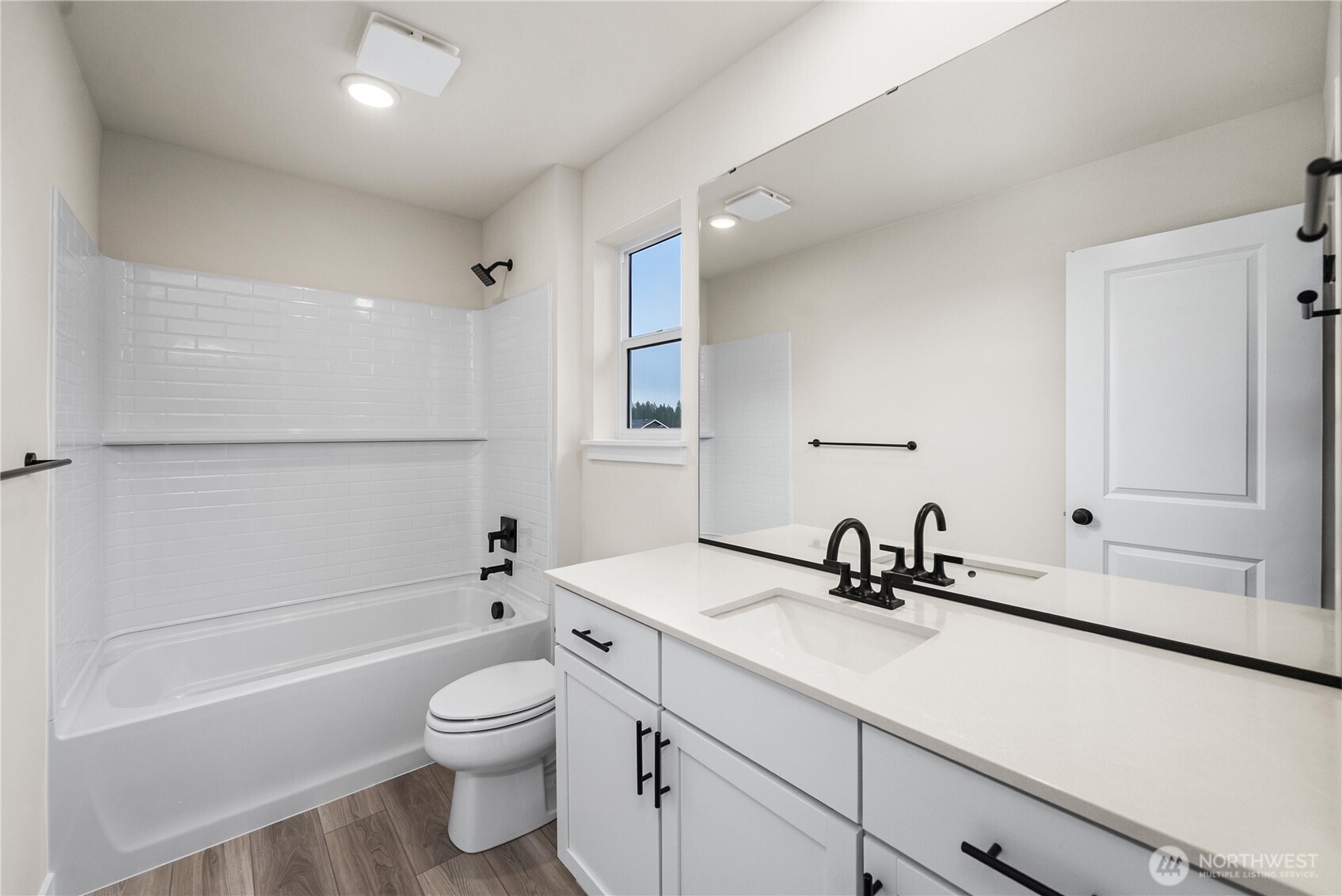5924 Trce Drive Southwest Port Orchard, WA 98367 - Photo 23 of 25 a bathroom with a toilet a sink a mirror a bathtub and vanity