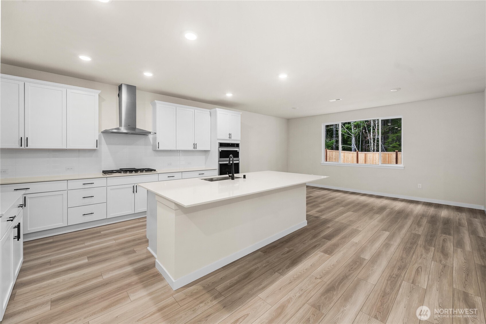 5924 Trce Drive Southwest Port Orchard, WA 98367 - Photo 6 of 25 a kitchen with stove cabinets and a wooden floor