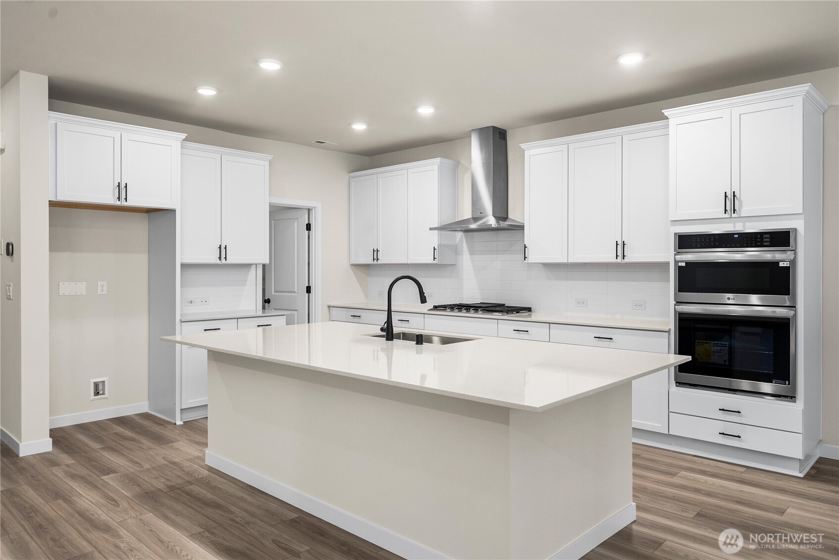 5924 Trce Drive Southwest Port Orchard, WA 98367 - Photo 7 of 25 a kitchen with kitchen island white cabinets and stainless steel appliances