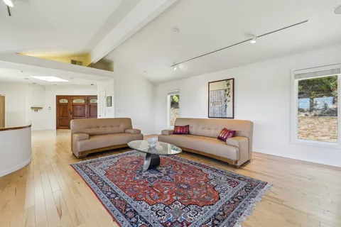 a large kitchen with stainless steel appliances granite countertop a stove and cabinets