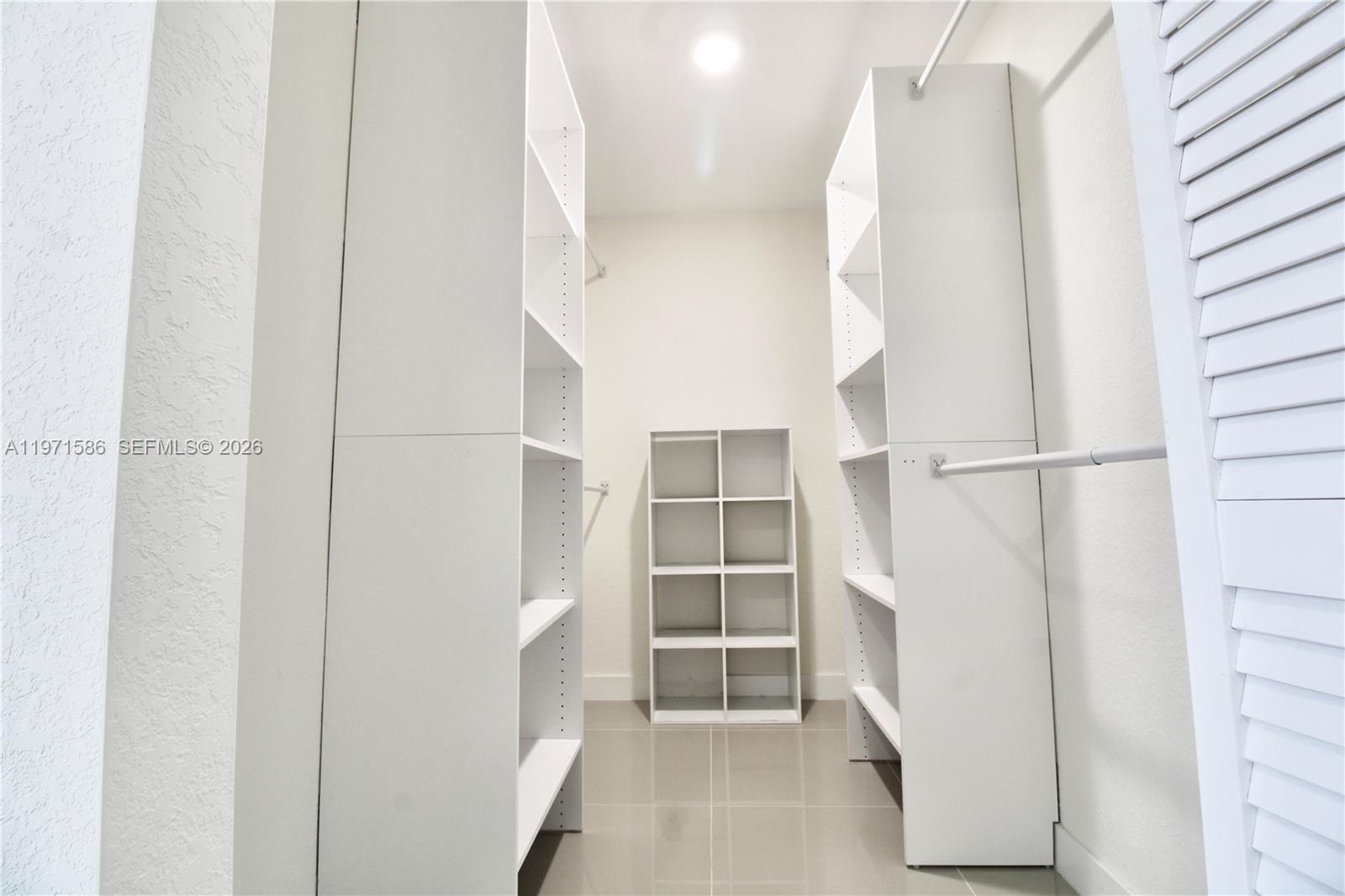 25875 Southwest 145th Avenue Homestead, FL 33032 - Photo 11 of 30 a view of closet area with empty racks
