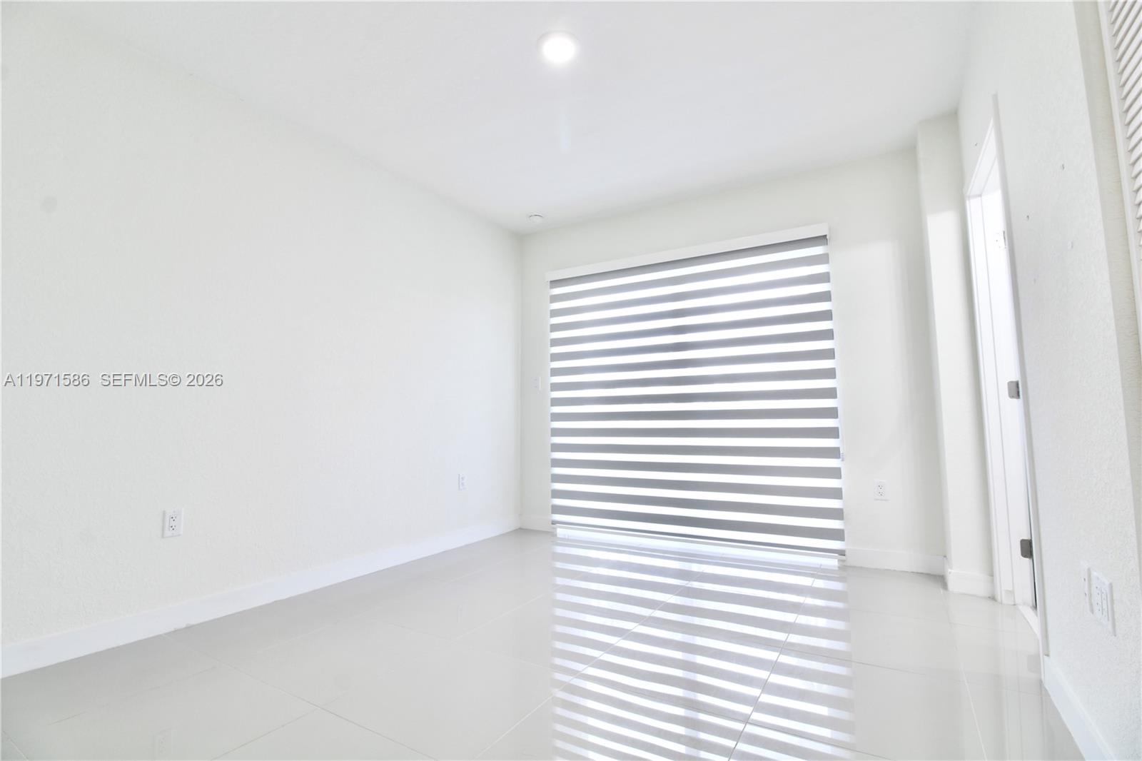 25875 Southwest 145th Avenue Homestead, FL 33032 - Photo 12 of 30 a view of a bedroom with a window