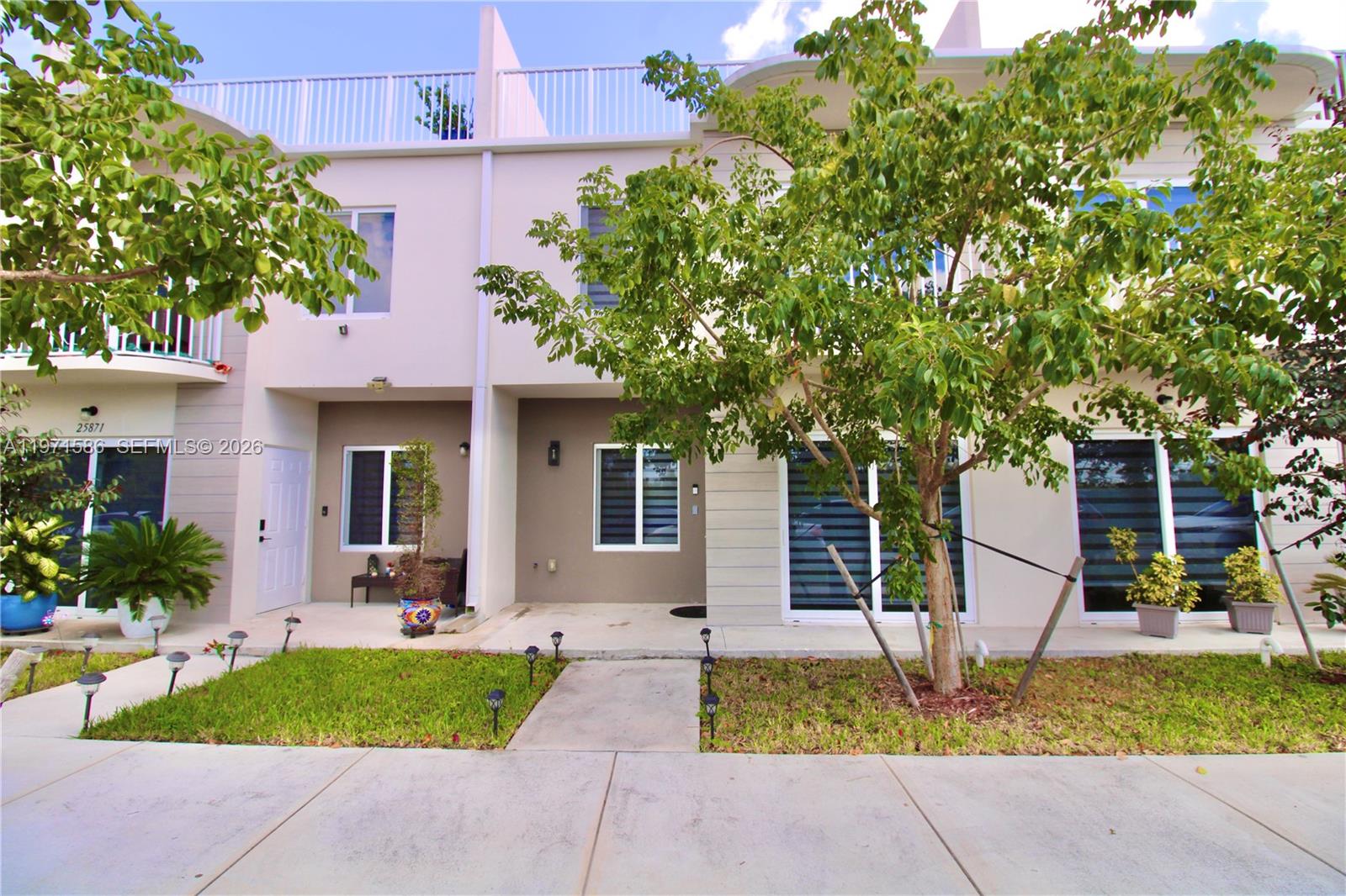 25875 Southwest 145th Avenue Homestead, FL 33032 - Photo 13 of 30 a front view of a house with garden