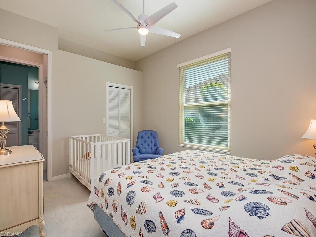 1832 Imperial Golf Course Boulevard Naples, FL 34110 - Photo 10 of 24 Bedroom with a closet, light carpet, and ceiling fan