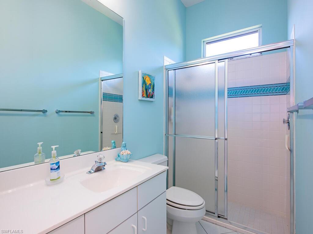 1832 Imperial Golf Course Boulevard Naples, FL 34110 - Photo 12 of 24 Full bathroom featuring vanity and a stall shower