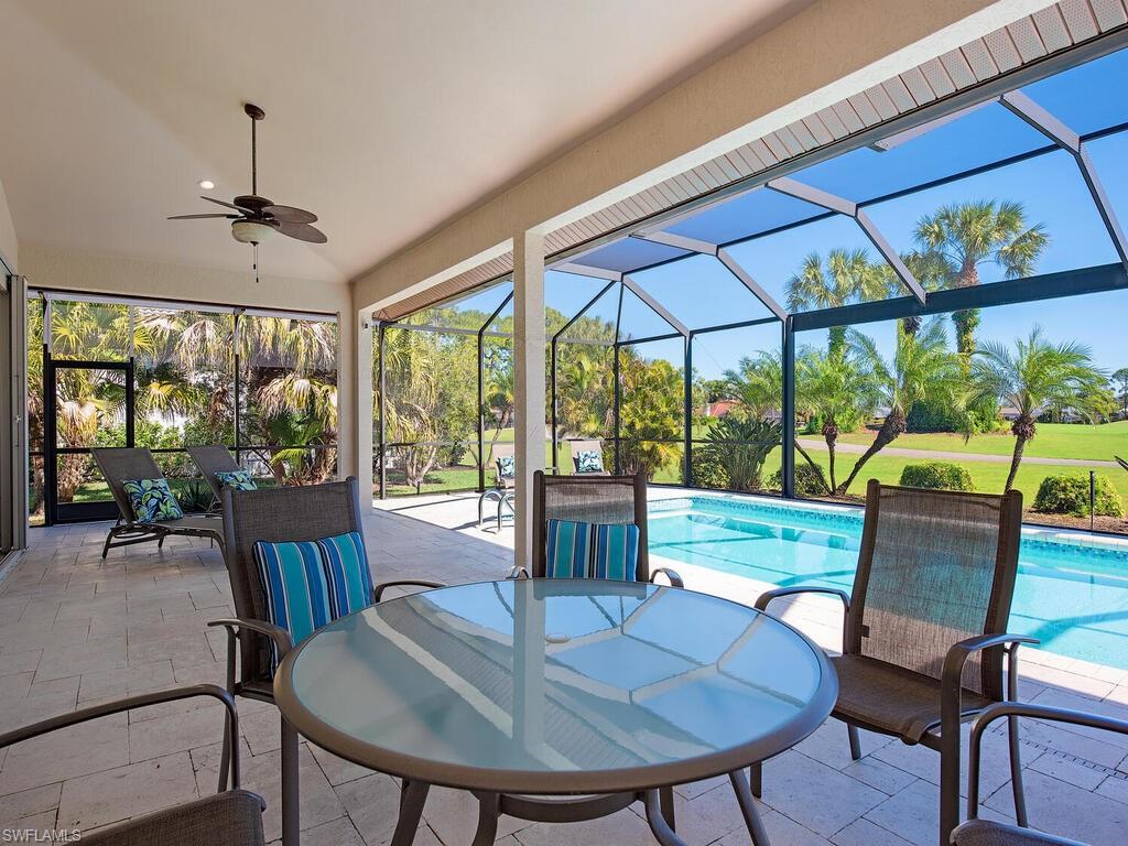 1832 Imperial Golf Course Boulevard Naples, FL 34110 - Photo 15 of 24 View of patio featuring outdoor dining area, an outdoor pool, glass enclosure, a ceiling fan, and a sunroom