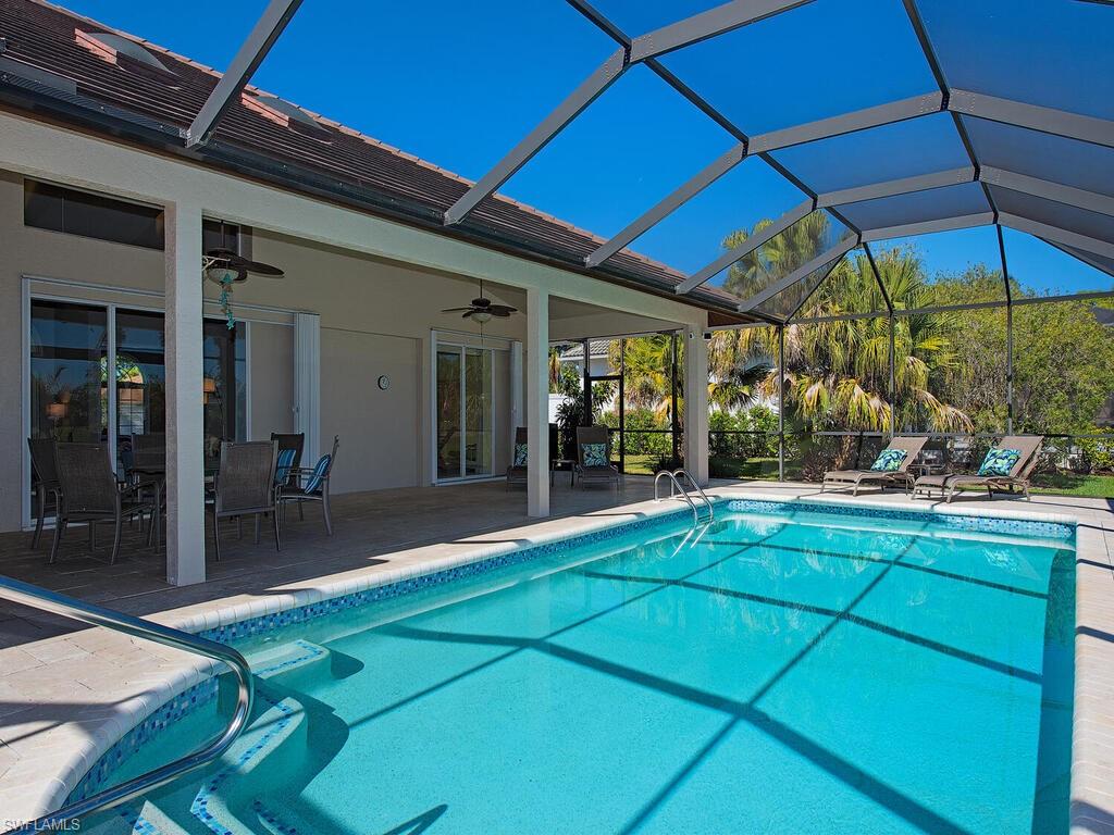 1832 Imperial Golf Course Boulevard Naples, FL 34110 - Photo 17 of 24 Swimming pool with outdoor dining area, a patio area, a sunroom, and glass enclosure