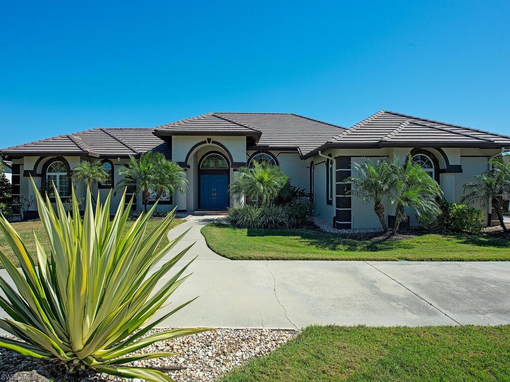 1832 Imperial Golf Course Boulevard Naples, FL 34110 - Photo 22 of 24 View of front facade featuring stucco siding, a tiled roof, and a front yard