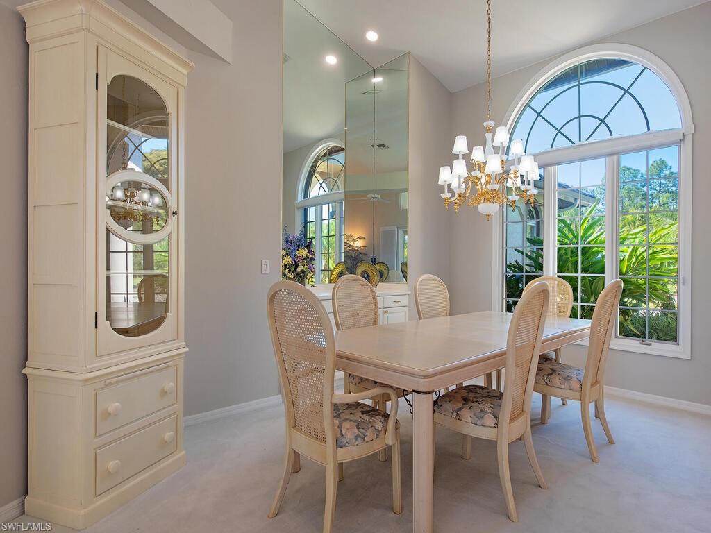 1832 Imperial Golf Course Boulevard Naples, FL 34110 - Photo 4 of 24 Dining room with a chandelier, light carpet, recessed lighting, and healthy amount of natural light