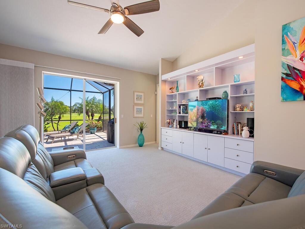 1832 Imperial Golf Course Boulevard Naples, FL 34110 - Photo 5 of 24 Living area with ceiling fan, a sunroom, and light carpet