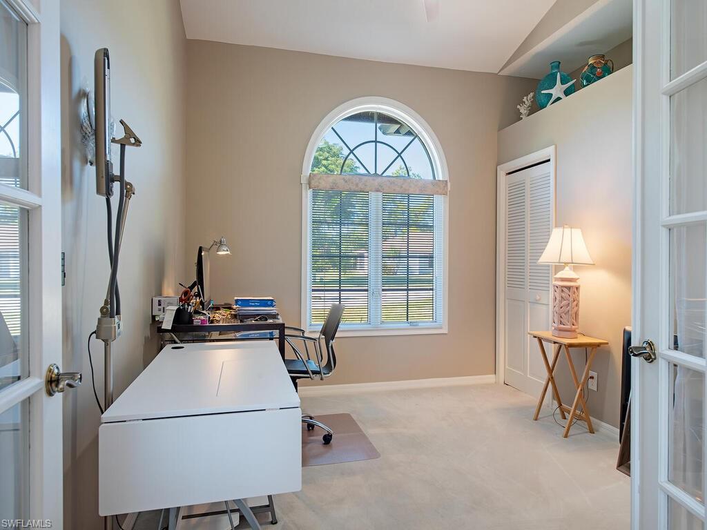 1832 Imperial Golf Course Boulevard Naples, FL 34110 - Photo 7 of 24 Home office with light colored carpet and french doors