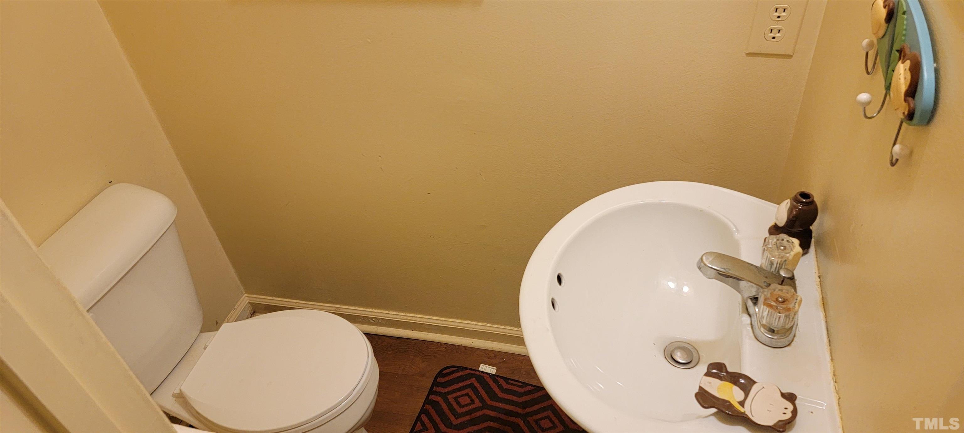 1304 Cherrycrest Drive Durham, NC 27704 - Photo 12 of 18 a bathroom with a toilet and a mirror