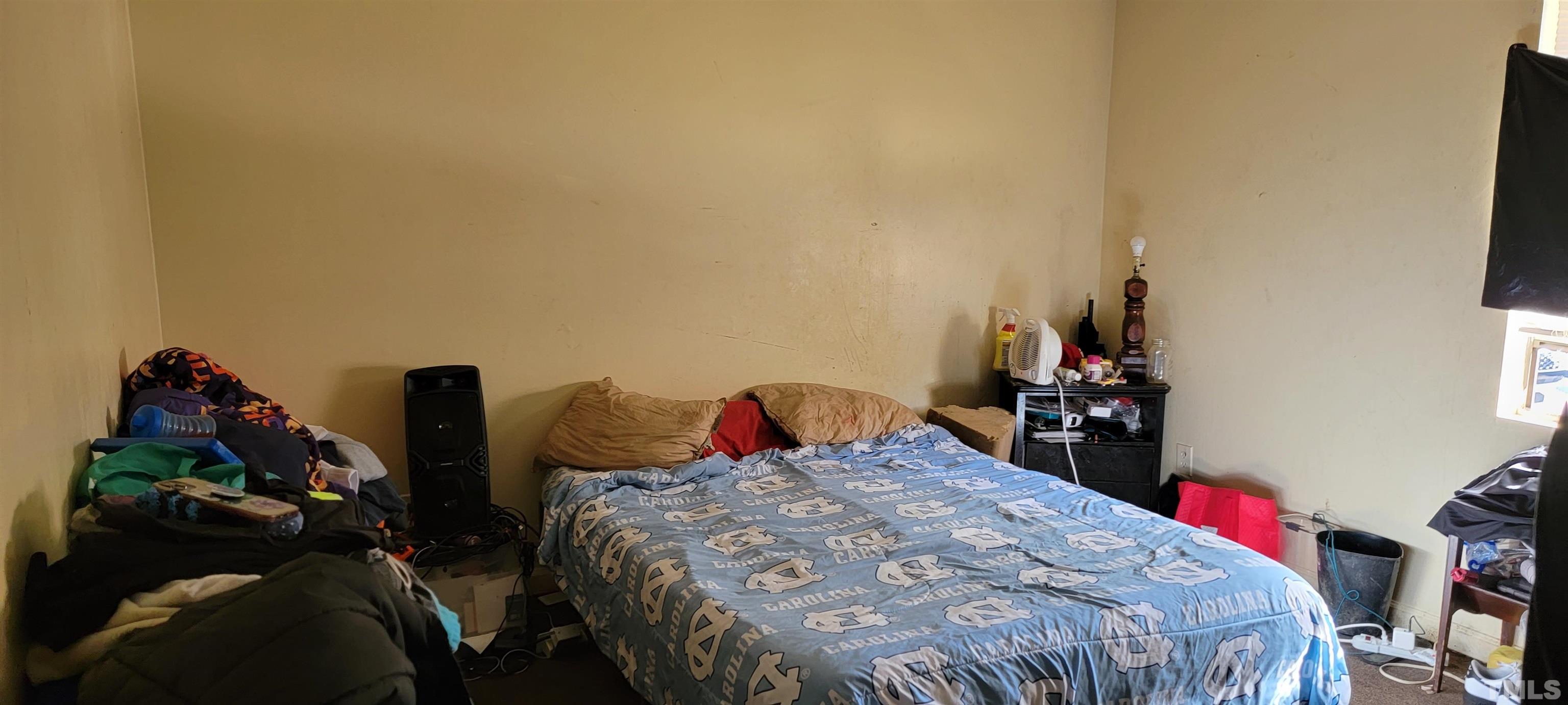 1304 Cherrycrest Drive Durham, NC 27704 - Photo 13 of 18 a bed sitting in a bedroom next to a window