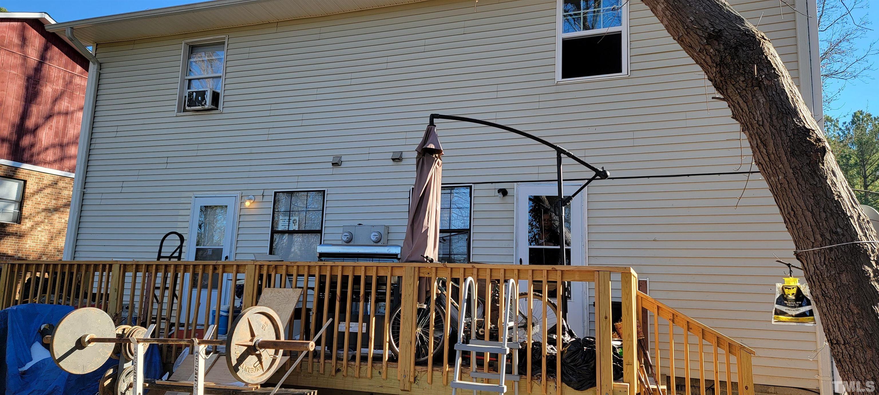 1304 Cherrycrest Drive Durham, NC 27704 - Photo 3 of 18 a view of a deck with wooden floor and fence and a floor to ceiling window