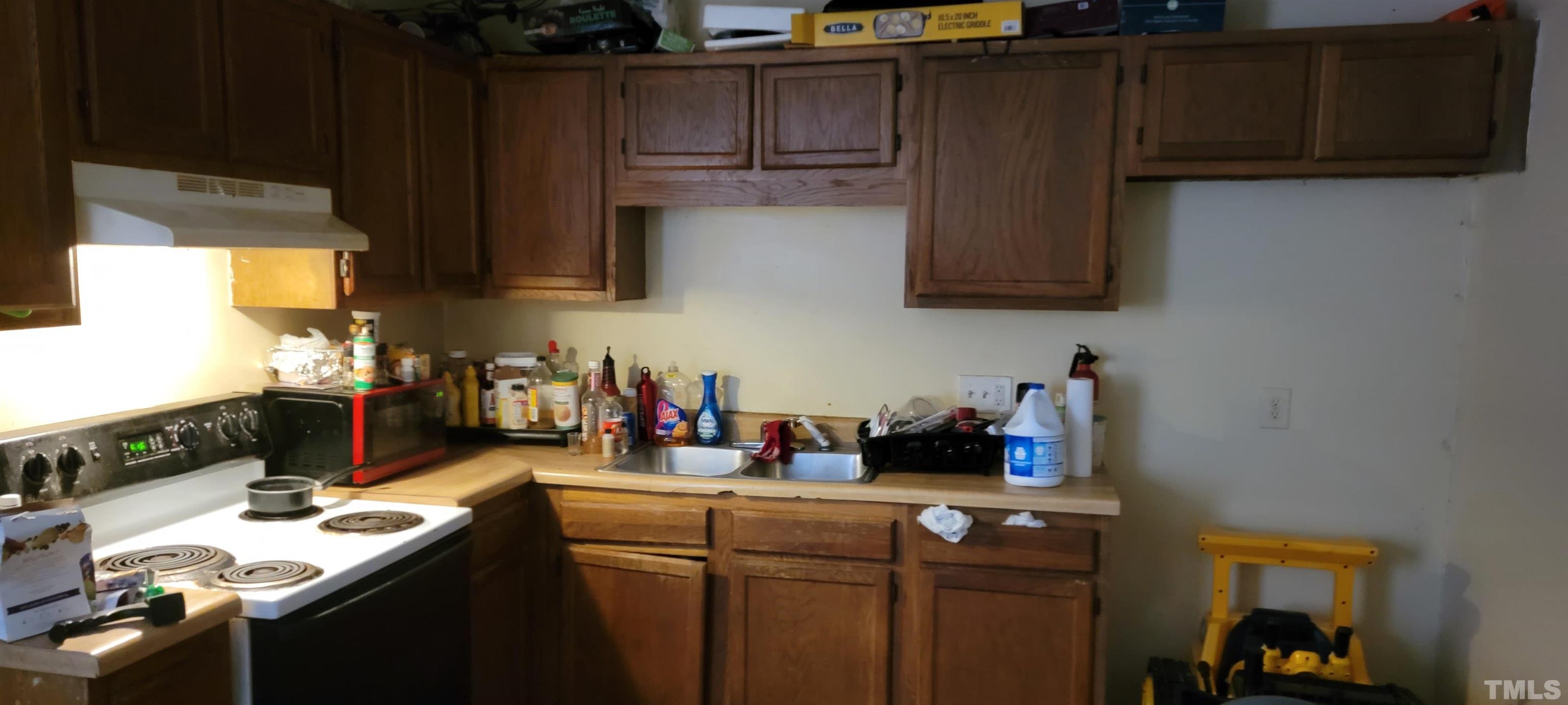 1304 Cherrycrest Drive Durham, NC 27704 - Photo 9 of 18 a kitchen with a sink and cabinets