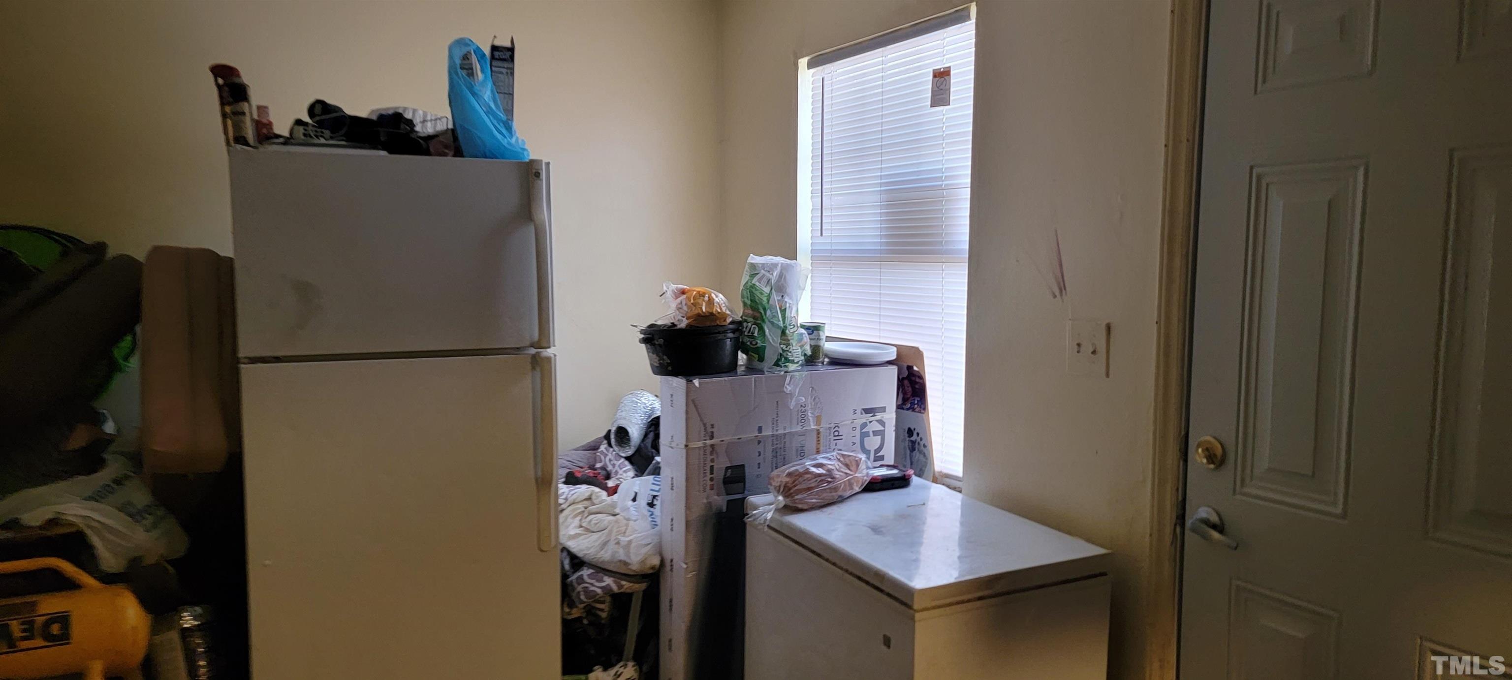 1304 Cherrycrest Drive Durham, NC 27704 - Photo 10 of 18 a room with a refrigerator and a table