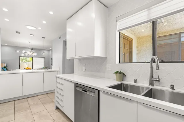 a kitchen with stainless steel appliances a stove microwave and refrigerator