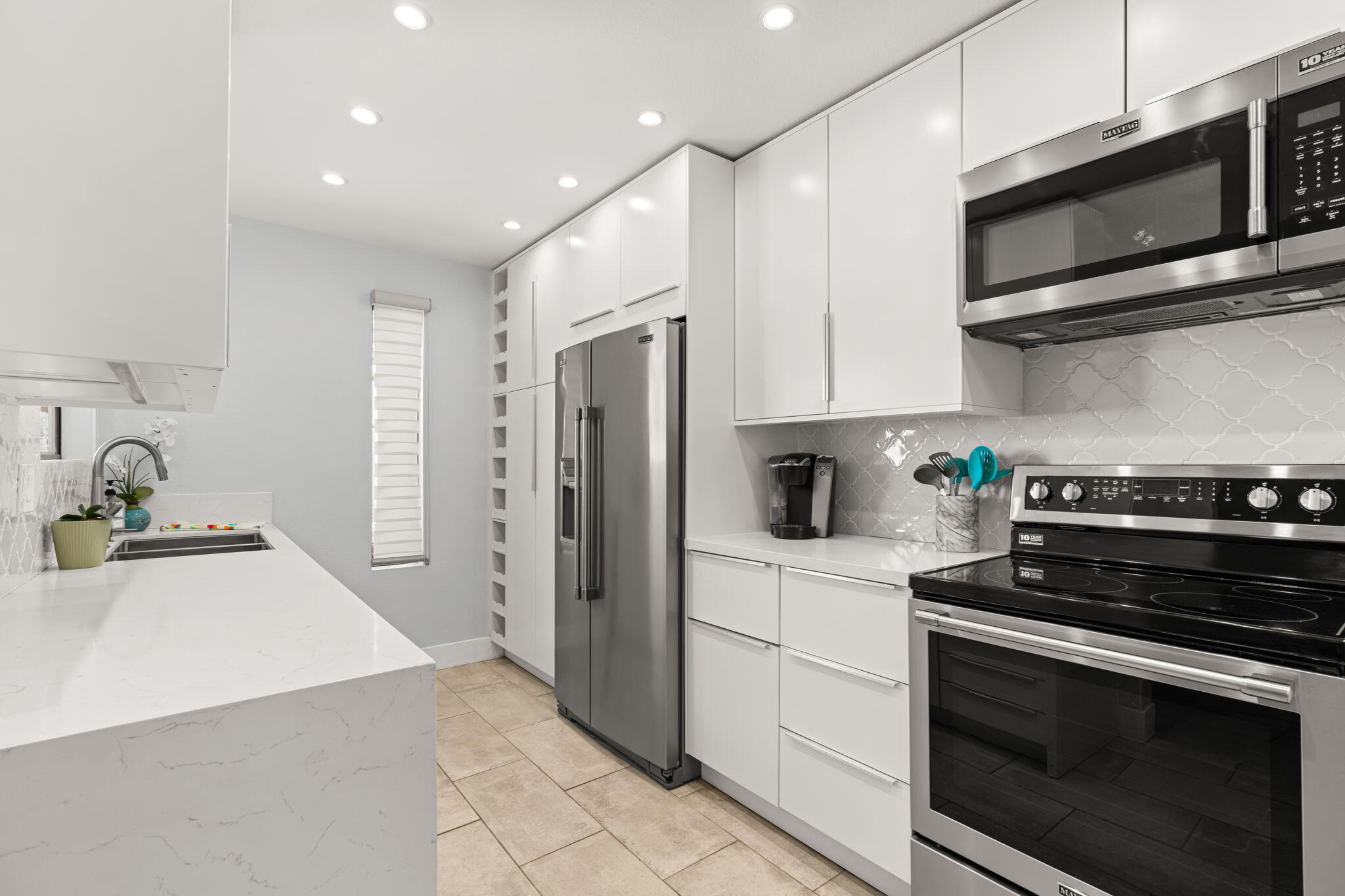 877 East Arenas Road Palm Springs, CA 92262 - Photo 15 of 43 a kitchen with stainless steel appliances a stove microwave and refrigerator