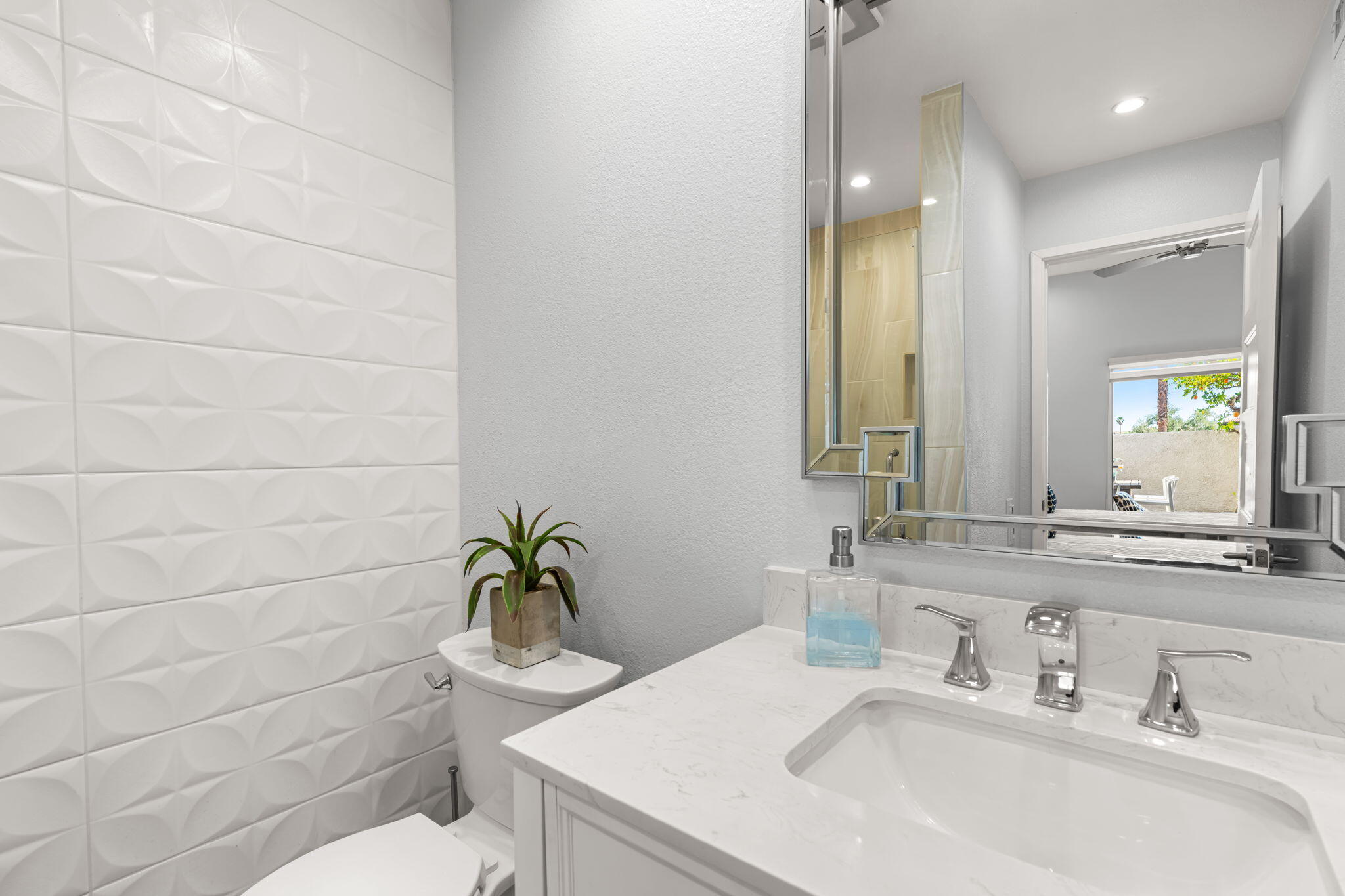 877 East Arenas Road Palm Springs, CA 92262 - Photo 22 of 43 a bathroom with a sink a toilet and mirror