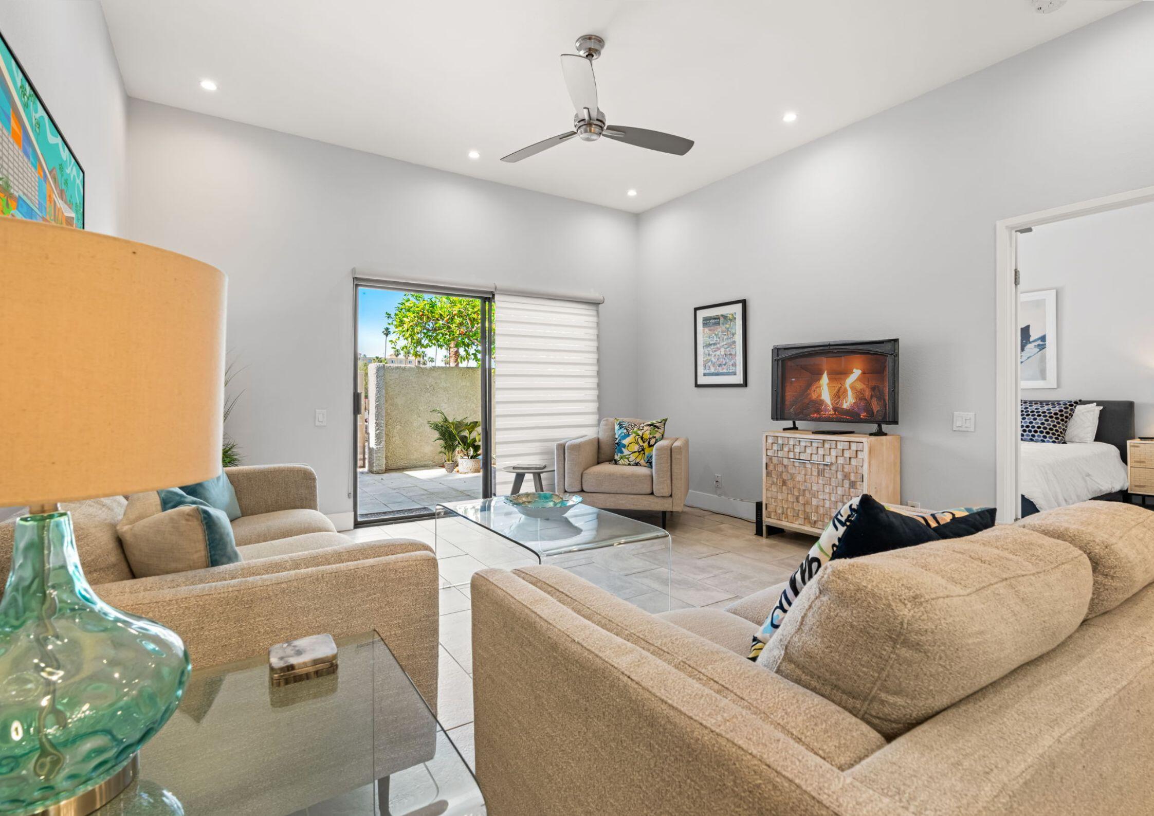 877 East Arenas Road Palm Springs, CA 92262 - Photo 3 of 43 a living room with furniture and a flat screen tv
