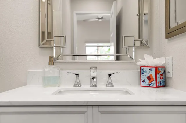 a view of a chandelier fan and kitchen view