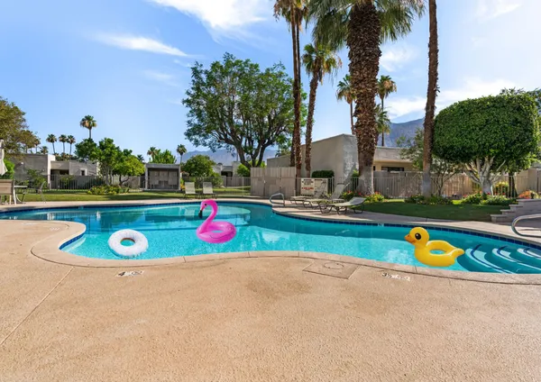 a view of swimming pool with outdoor seating and plants