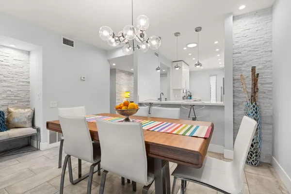 a kitchen with stainless steel appliances granite countertop cabinets and a wooden floor