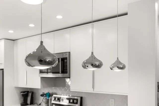 a view of a patio with table and chairs and floor to ceiling window