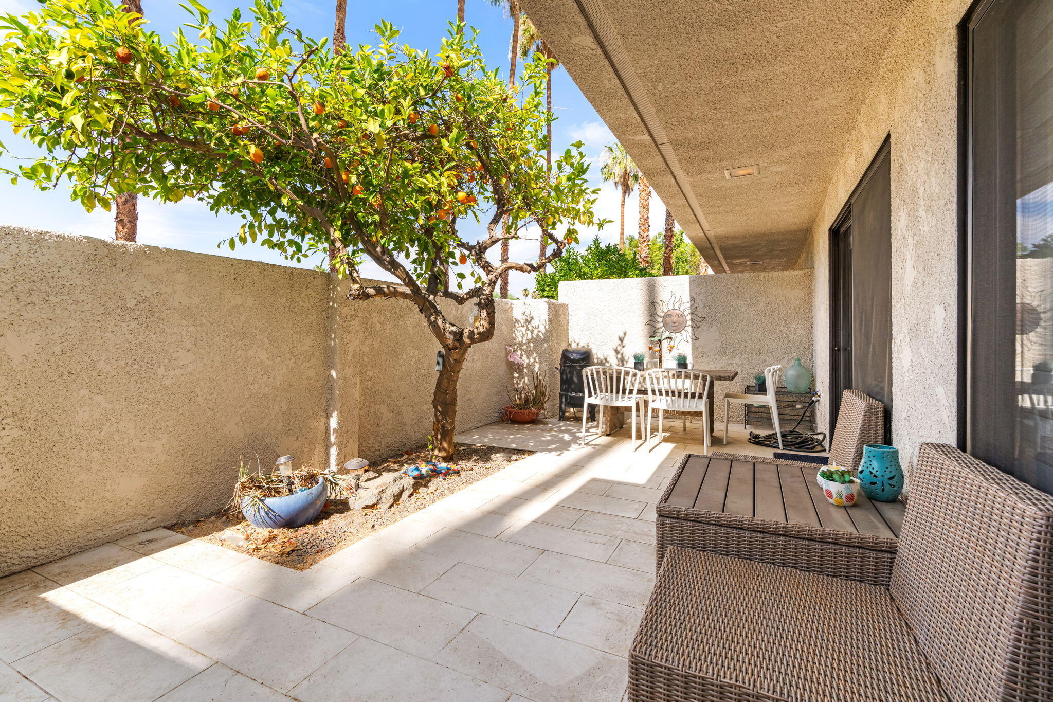 877 East Arenas Road Palm Springs, CA 92262 - Photo 6 of 43 a view of a patio with table and chairs and floor to ceiling window