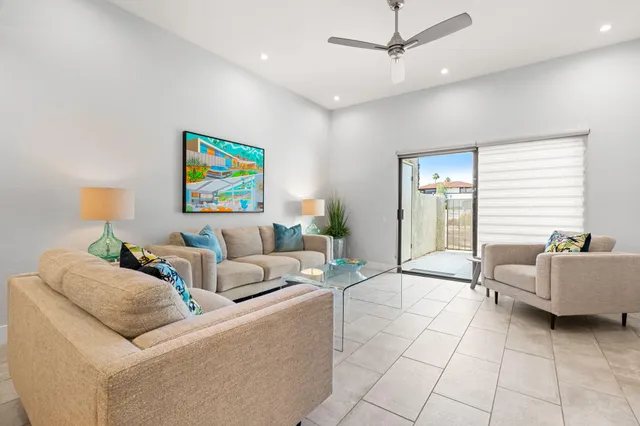 a view of a dining room with furniture and a chandelier