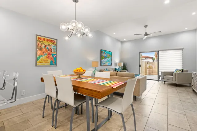 a living room with furniture and painting on the wall