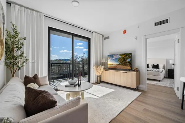 a living room with furniture and a potted plant