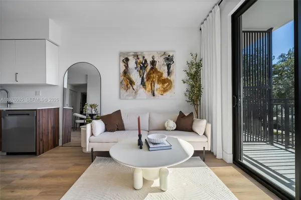 a living room with furniture and wooden floor