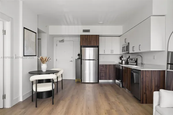 a kitchen with stainless steel appliances a refrigerator and a stove top oven