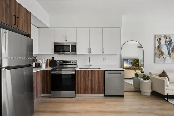 a kitchen with stainless steel appliances and a refrigerator