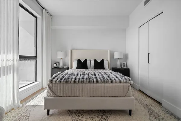 a bedroom with a bed and window