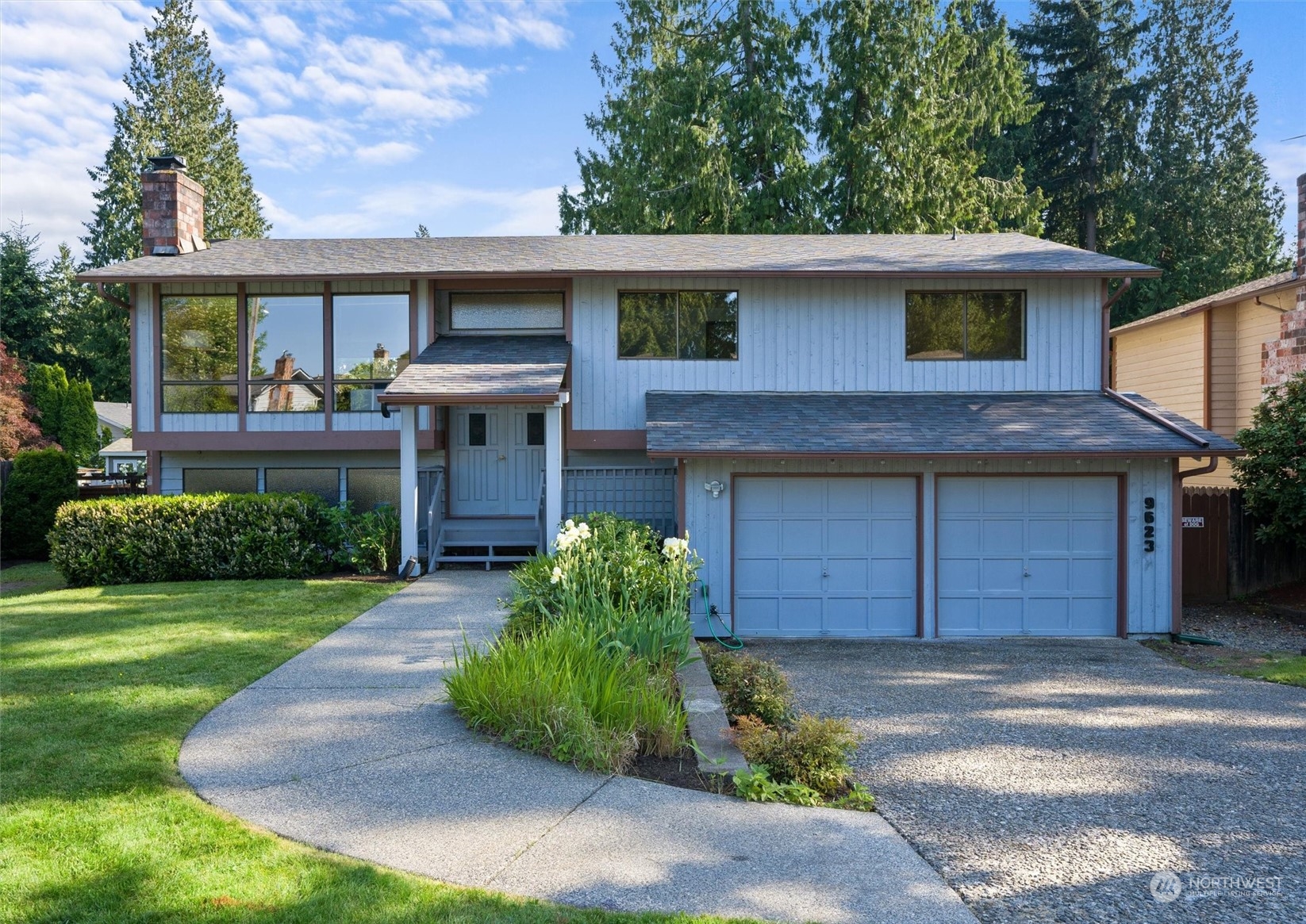 9623 Northeast 204th Place Bothell, WA 98011 - Photo 1 of 26 a front view of a house with a garden and garage