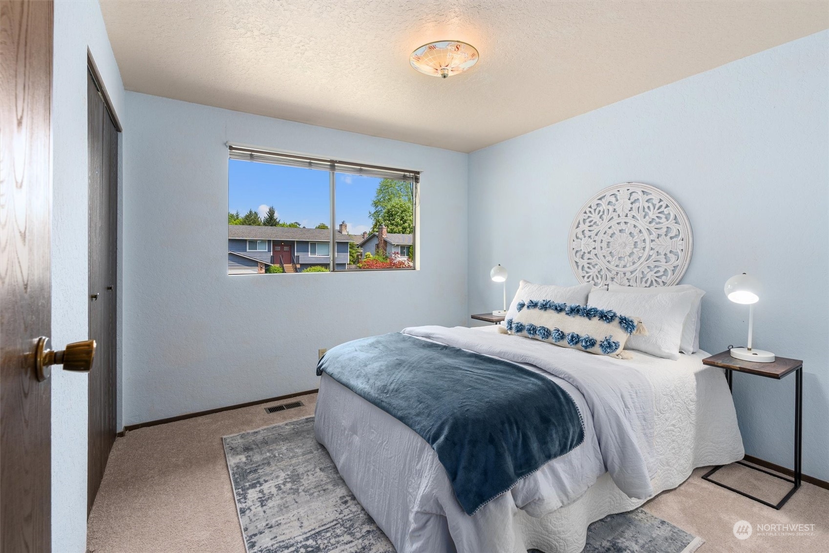 9623 Northeast 204th Place Bothell, WA 98011 - Photo 13 of 26 a bedroom with a bed and a painting on the wall
