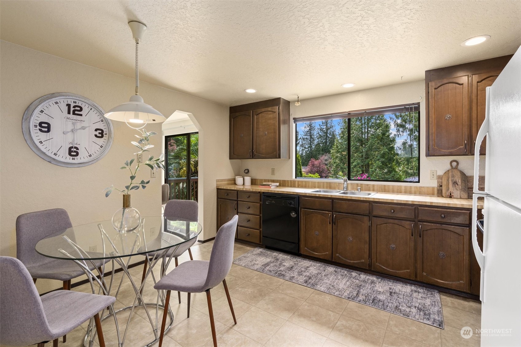 9623 Northeast 204th Place Bothell, WA 98011 - Photo 8 of 26 a kitchen with a table chairs and a dining table