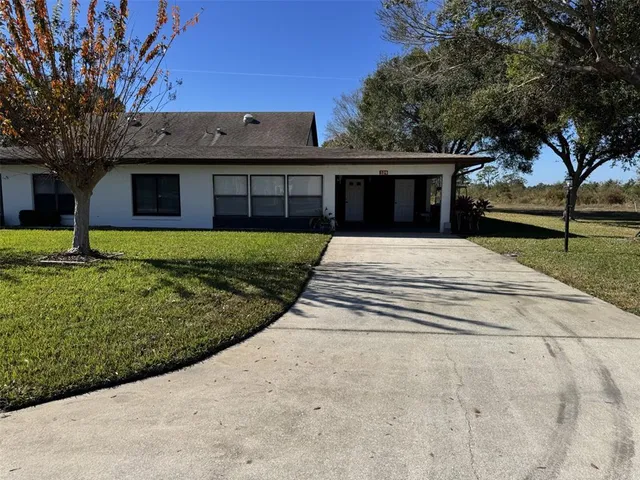 a view of a house with a backyard