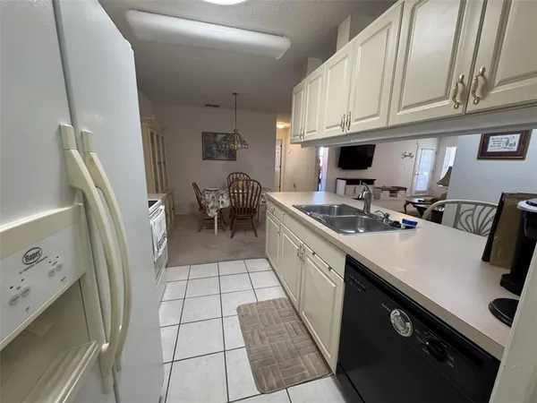 a kitchen with a sink a stove and a refrigerator