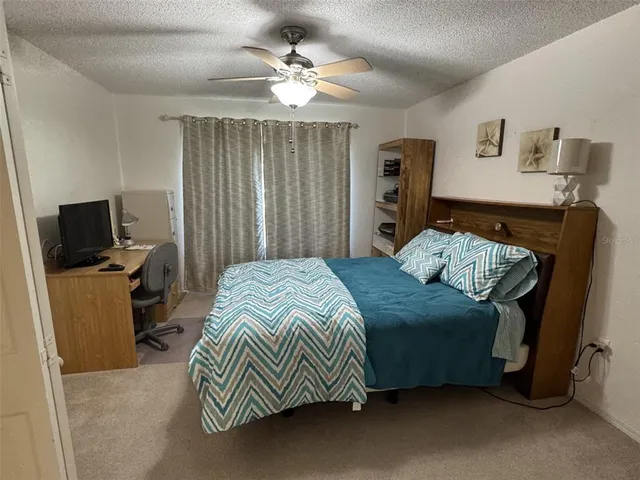 a bedroom with a bed and a television