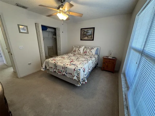 a bed sitting in a bedroom next to a window