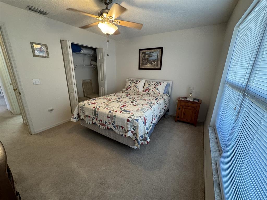 329 Genesis Pointe Drive, Unit 329 Lake Wales, FL 33859 - Photo 20 of 29 a bed sitting in a bedroom next to a window